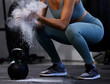 © Nadia L/peopleimages.com - Woman, hand powder and kettlebell for workout, exercise and fitness in the gym, start and prepare for healthy lifestyle. Female athlete, hands and weight training, body builder and power performance