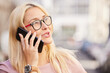© Garfield K/peopleimages.com - Phone call, city and business woman networking, online communication and negotiation for design, brand strategy and marketing. Blurred background, urban and creative startup woman talk on smartphone