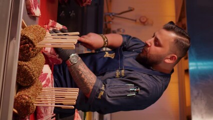 Wall Mural - Vertical Screen: Butcher cutting raw fresh beef meat ribeye steak. Cook preparing the meat to be seasoned.