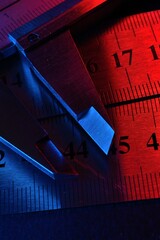 Wall Mural - caliper and metal rulers illuminated in red and blue. close-up