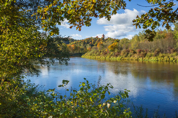 Wall Mural - View to Turaida Castle on sunny autumn day. River of Gauja in the foreground