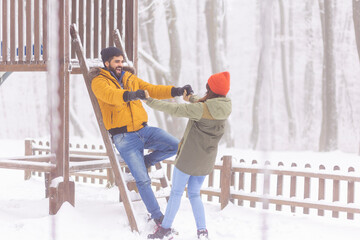 Wall Mural - Couple relaxing outdoors on snowy winter day