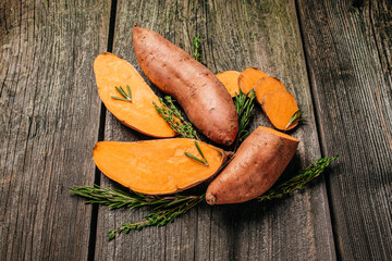 Wall Mural - Organic orange sweet potato. Raw sweet potatoes or batatas. vegan food ingredient. banner, menu, recipe place for text, top view