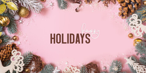 Wall Mural - Happy Holidays greeting card with Xmas decoration on pink background. Noel. Flat lay. Banner