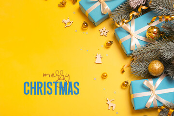 Wall Mural - merry christmas text on yellow background with blue gifts, pine tree and festive decorations top vie