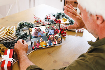 Sticker - Senior caucasian man having christmas video call with diverse people