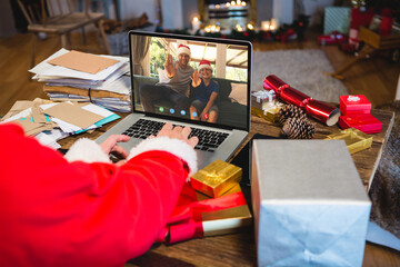 Wall Mural - Senior caucasian man having christmas video call with caucasian man and his son