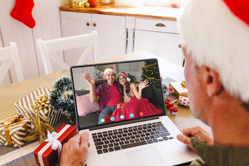 Sticker - Caucasian man with santa hat having video call with happy caucasian couple