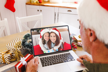 Poster - Caucasian man with santa hat having video call with happy caucasian couple