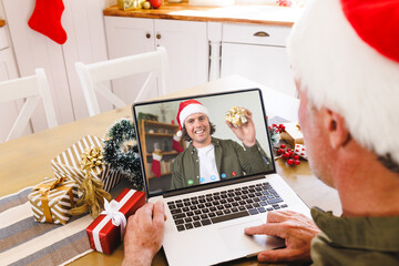 Poster - Caucasian man with santa hat having video call with happy caucasian man