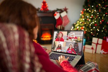 Poster - Caucasian woman with christmas decorations having video call with happy caucasian children