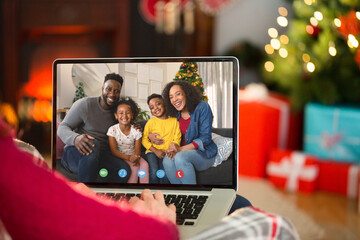 Sticker - Caucasian woman with christmas decorations having video call with happy african american family