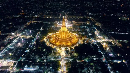 Wall Mural - Majestic golden pagoda of Phra Pathom Chedi glowing among the festival lights around the roundabout road in downtown at Nakhon Pathom