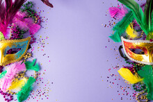 Colourful Mardi Gras Beads, Feathers And Carnival Masks On Blue Background With Copy Space