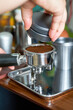 © Steve - A barista making espresso with a coffee machine