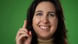 © Robert Peak - Young woman 20s has great idea, points up with finger isolated on green screen closeup portrait background studio
