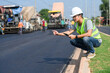 © เลิศลักษณ์ ทิพชัย - Asian male architectural engineer work at road construction site For working on road construction sites and inspecting the development of paved road construction projects.