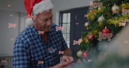 Sticker - Animation of joy text over senior caucasian couple wearing santa hat