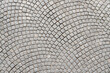 Grey cobblestone pavement abstract background surface top close up view