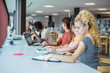 © Ivan - Group of students from diverse backgrounds in the library sharing notes and study time together