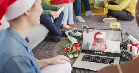 Sticker - Diverse group of friends having christmas video call with senior african american woman