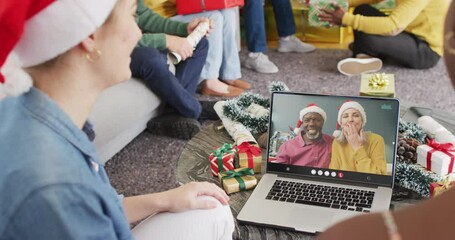 Canvas Print - Diverse group of friends having christmas video call with senior diverse couple