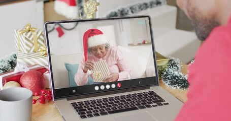 Poster - African american man having christmas video call with senior african american woman