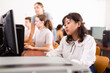 © JackF - Teen schoolgirl learning basics of programming in group course in computer college