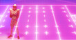 Leinwandbild Motiv Composite of illuminated american football field and player with ball standing over pink background