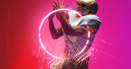 Sticker - American football player catching ball while standing by illuminated circle and plants, copy space