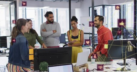 Canvas Print - Animation of network of social media icons over happy diverse colleagues in office