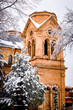 Snowy winter scene in Santa Fe, vertical view of church and trees