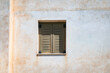 © Chris Allan - Photo of a shuttered window on the side of a house in a small town on the Greek island or Paros.