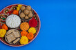 Happy Makar Sankranti, Pongal and Uttarayan with Kite, haldi kum kum bowls and tilgul sweets