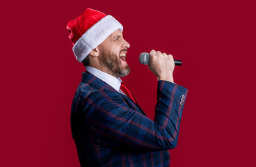 Wall Mural - merry christmas. smiling event host man singing at christmas isolated on red. christmas event host