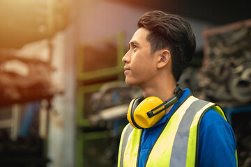 Confident proud Asian male engineer worker standing happy smile for enjoy working in factory