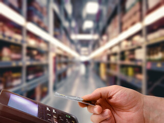 Wall Mural - supermarket with blurred background and contactless payments from pos device via credit card