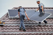 © anatoliy_gleb - Men technicians carrying photovoltaic solar moduls on roof of house. Workmen in helmets mounting solar panel system outdoors. Concept of alternative and renewable energy.