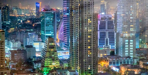 Wall Mural - City skyline aerial view at night in Bangkok, Thailand.