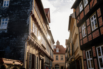 Wall Mural - Quedlinburg, Saxony-Anhalt, Germany, 28 October 2022: Historic old vintage colored timber frame houses in medieval town, UNESCO World Heritage city, half-timbered home at sunny autumn day, cobblestone