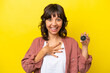 © luismolinero - Young latin woman holding compass isolated on yellow background smiling a lot