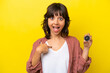 © luismolinero - Young latin woman holding compass isolated on yellow background with surprise facial expression