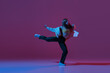 © Lustre Art Group  - Flexible young girl, contemp dancer dancing hip-hop or experimental dance isolated on dark purple background in neon. Contemporary dance. Music, dance, active lifestyle, fashion, style