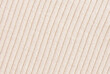 Soft beige ribbed knit fabric pattern close up as background