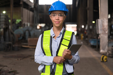 Portrait Latin America woman engineer holding tablet computer at factory	