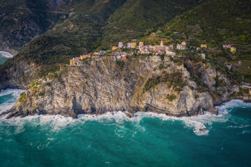 Wall Mural - Italy, Liguria, Cinque Terre, Corniglia, Multi colored town architecture among hills. Aerial drone view from the seaside. September 2022