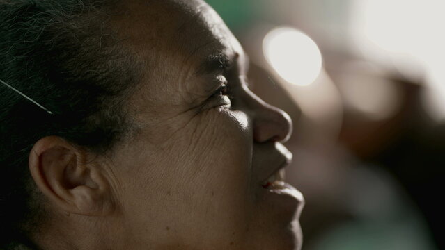 Happy senior woman looking at sky with HOPE profile closeup face. Older mature South American Brazilian lady having FAITH