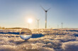 lensball in the snow and a wind farm in the Ore Mountains in the Czech Republic