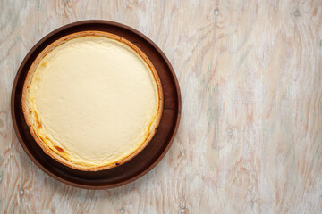 Wall Mural - Cheesecake New York  on a plate on a wooden background. Top view. Copy space