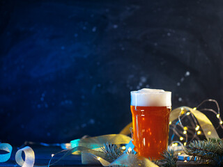 Canvas Print - glass of light beer on a Christmas background copy space